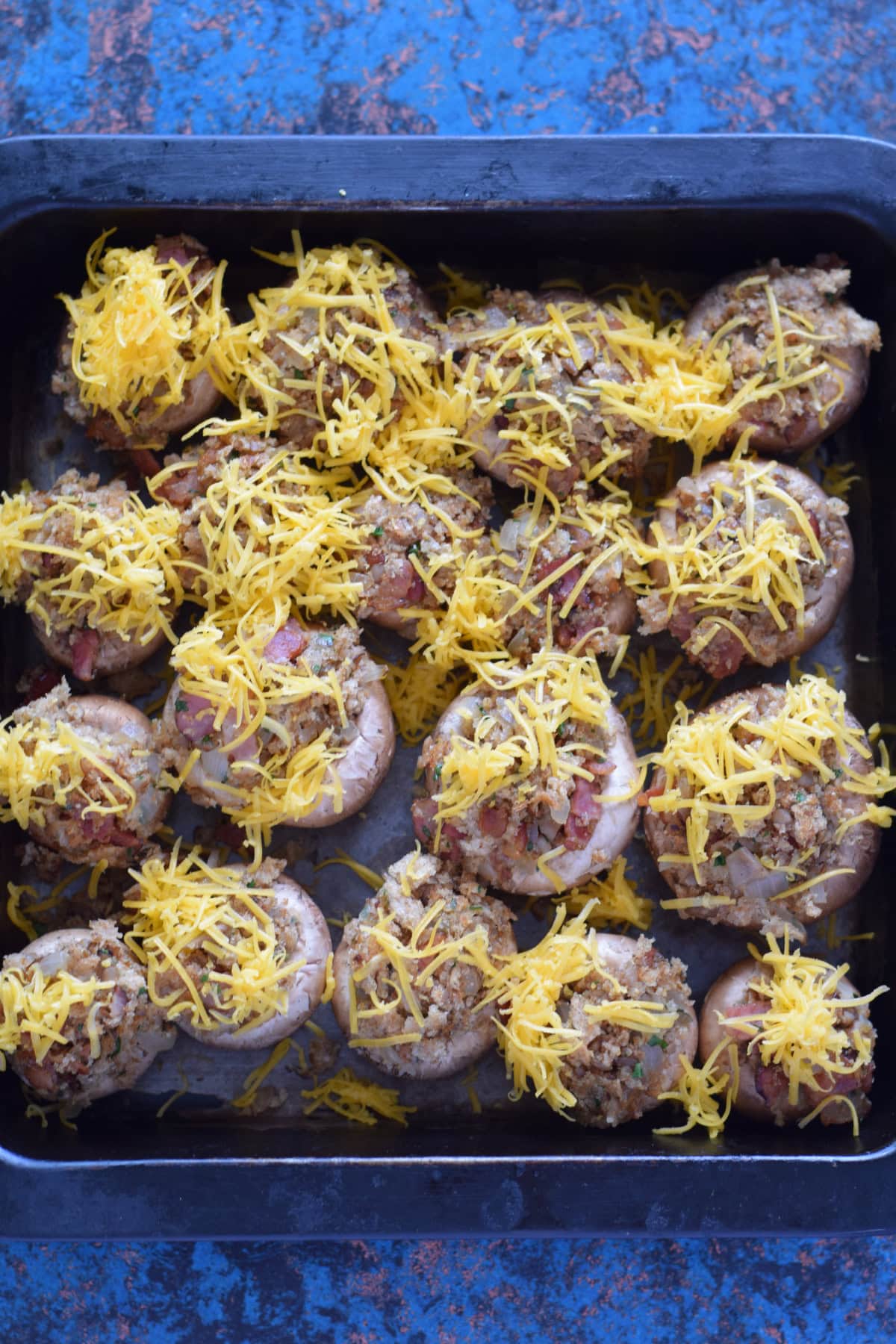 Stuffed mushrooms topped with cheddar cheese.