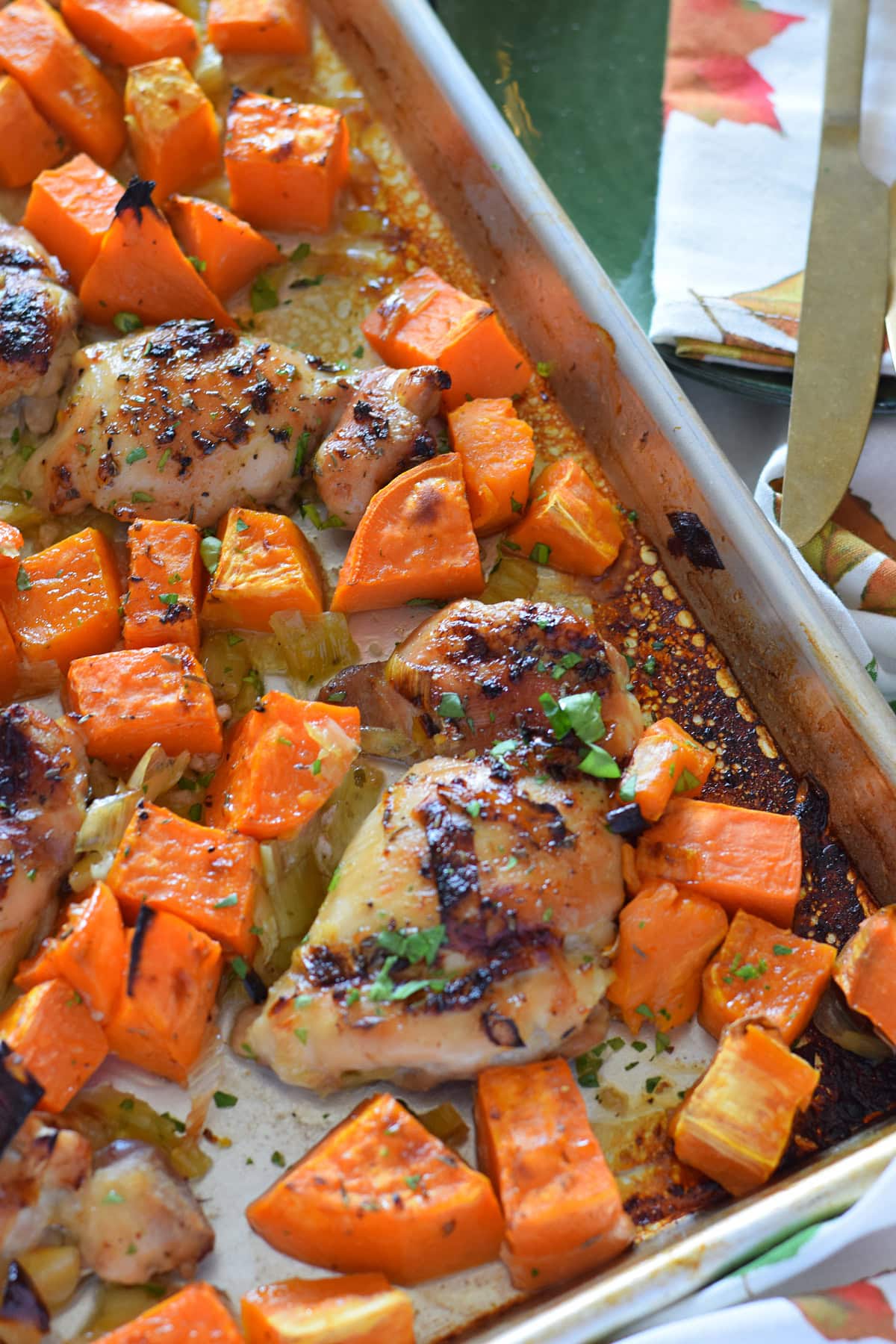 Close up of sheet pan chicken and sweet potatoes.