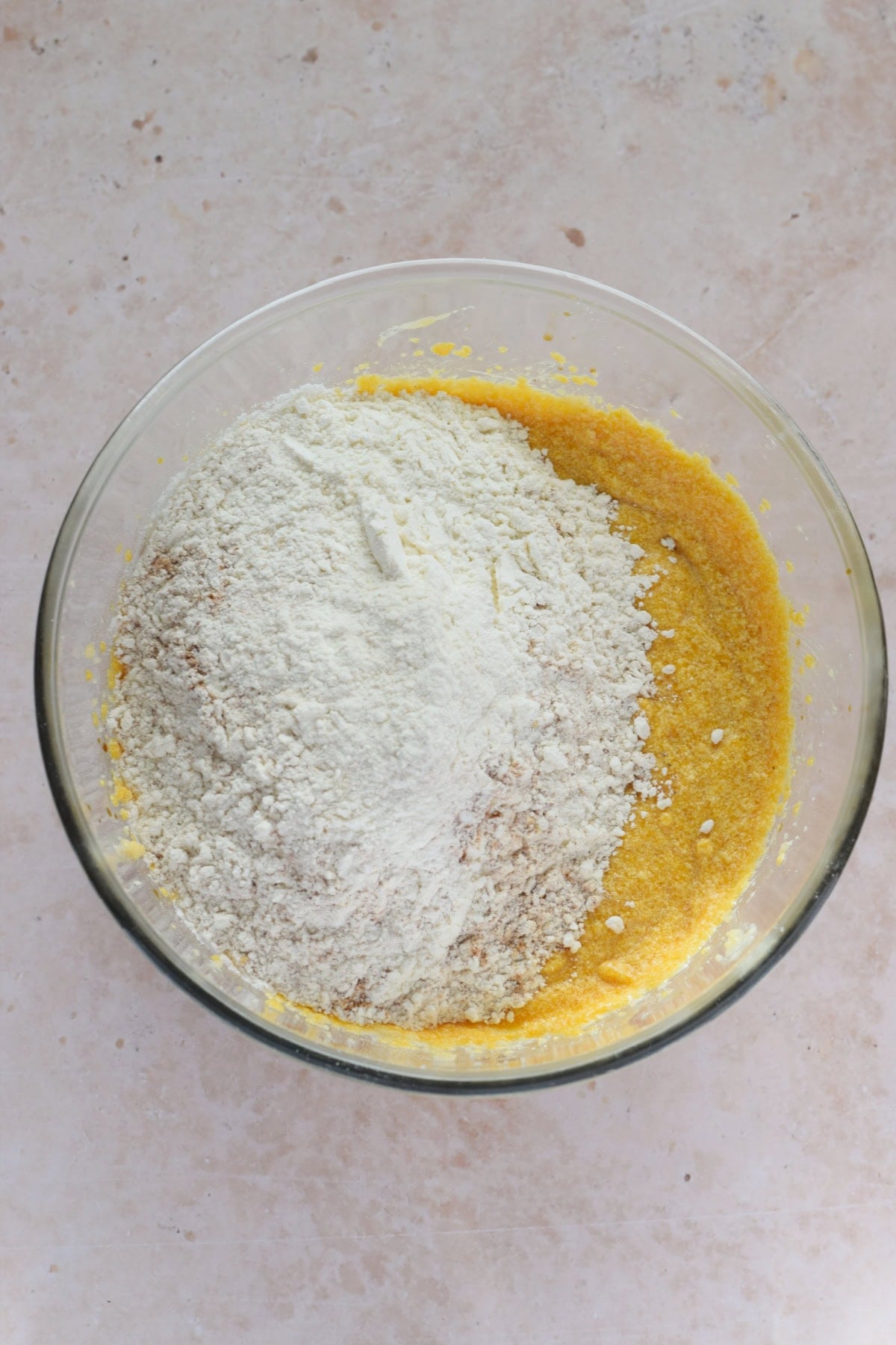 Adding flour to muffin batter.