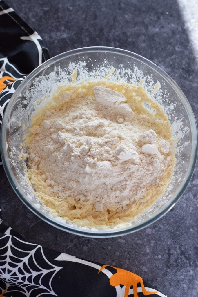 Adding dry ingredients to cookie dough.