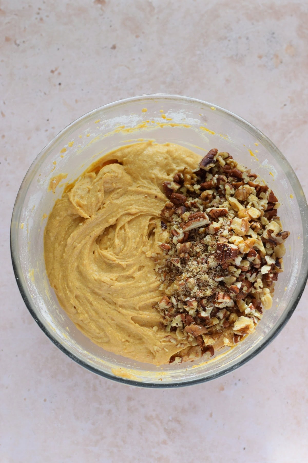 Adding walnuts to muffin batter.