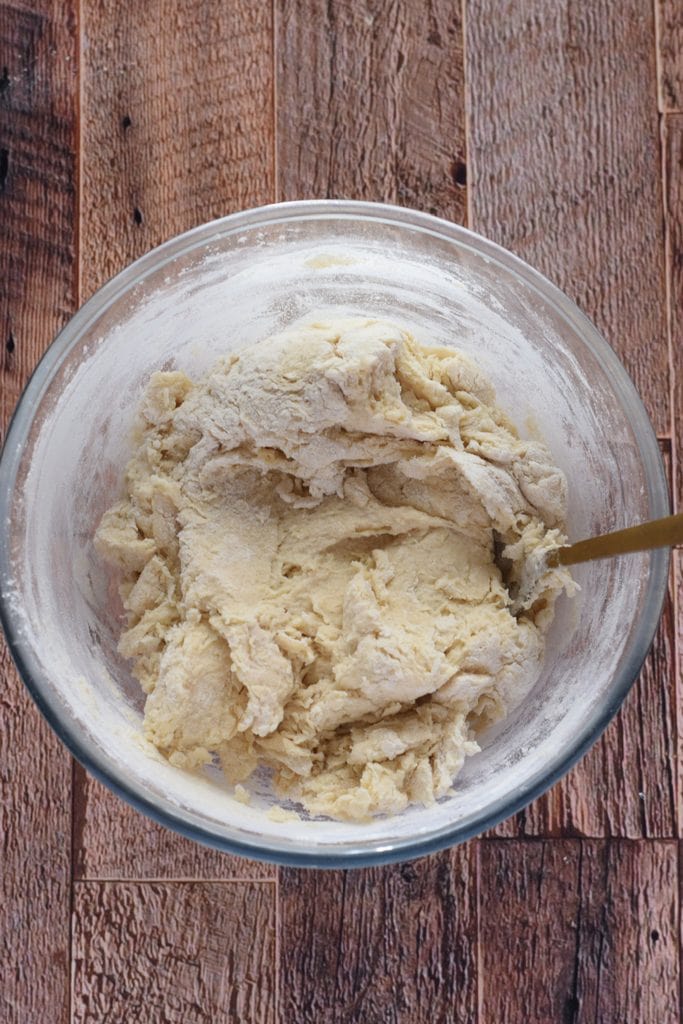 Making bread dough in a glass bowl.