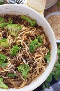 Close up of a ground beef stir fry in a white skillet.