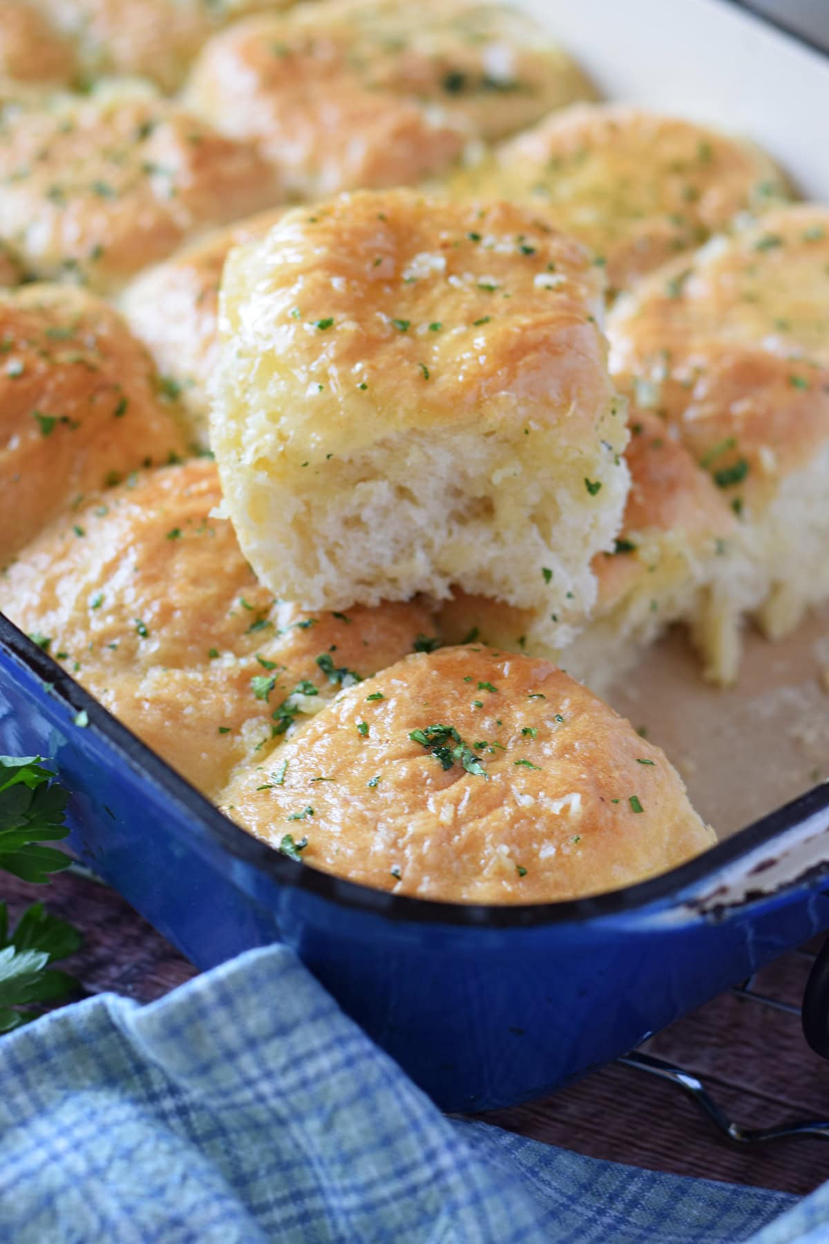 Close up of fluffy dinner rolls with garlic butter.