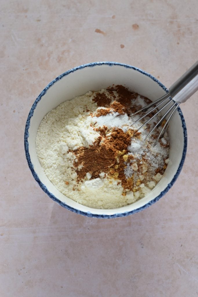 Combined dry ingredients in a glass bowl for muffins.