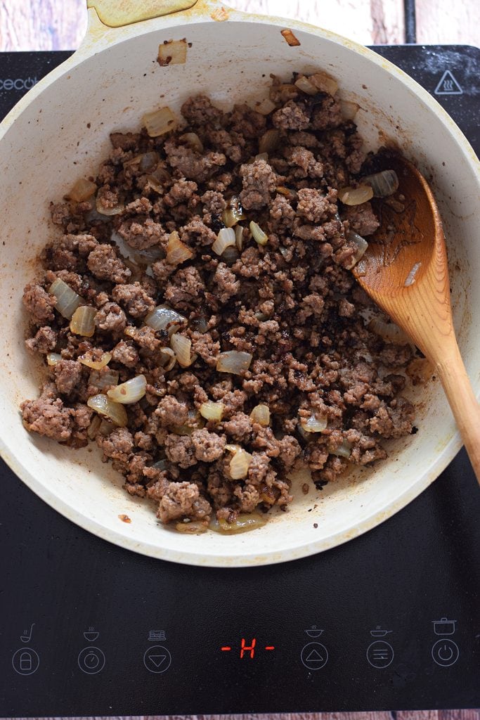 Cooked ground beef in a skillet.