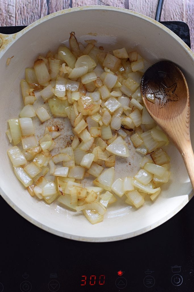 Cooking onions in a skillet.