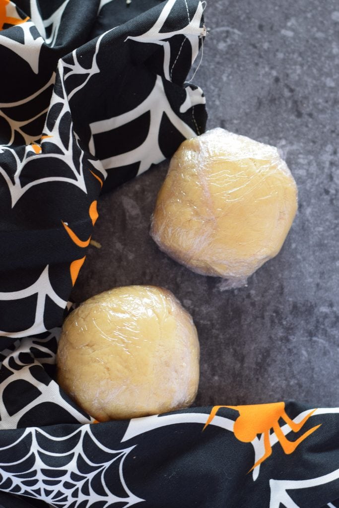 Dough balls wrapped in plastic wrap.