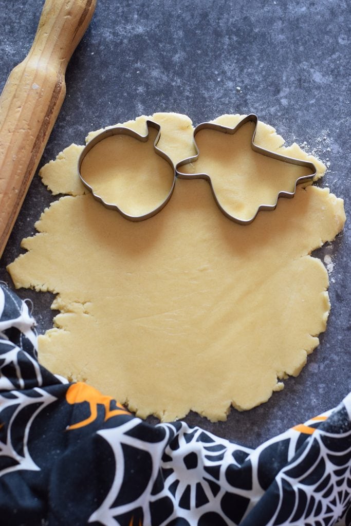 Cutting out Halloween cookies.