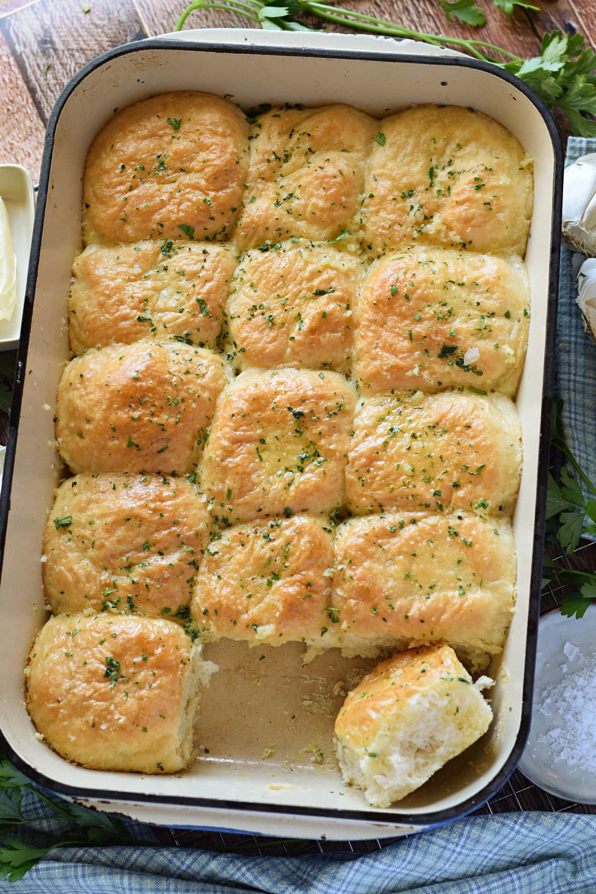Dinner rolls with garlic butter in a baking dish.