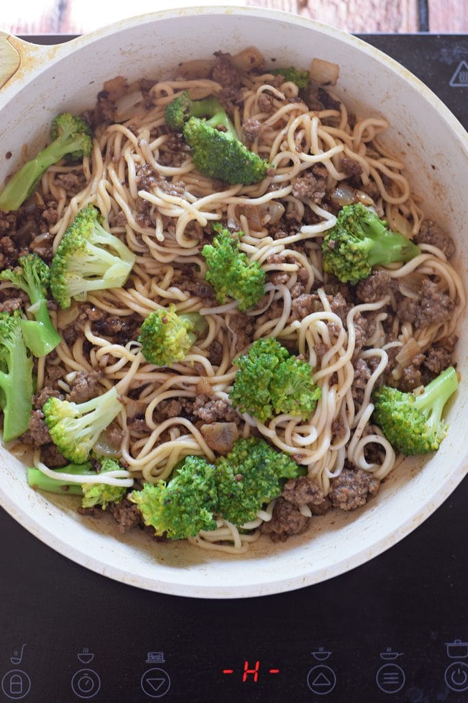 Beef and broccoli stir fry in a skillet.