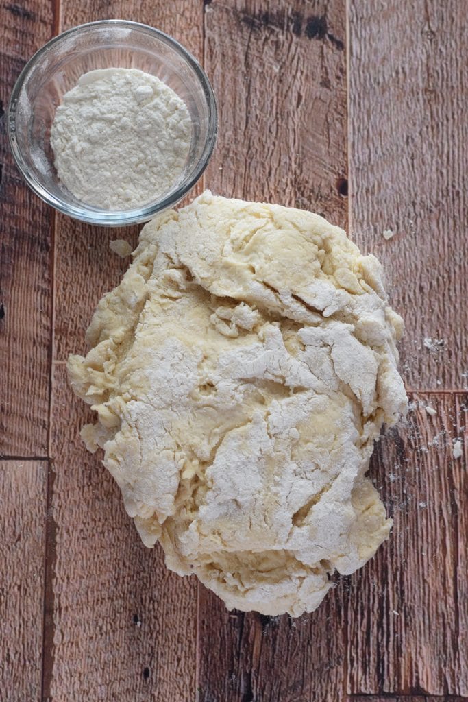 Making bread dough on a wooden table.