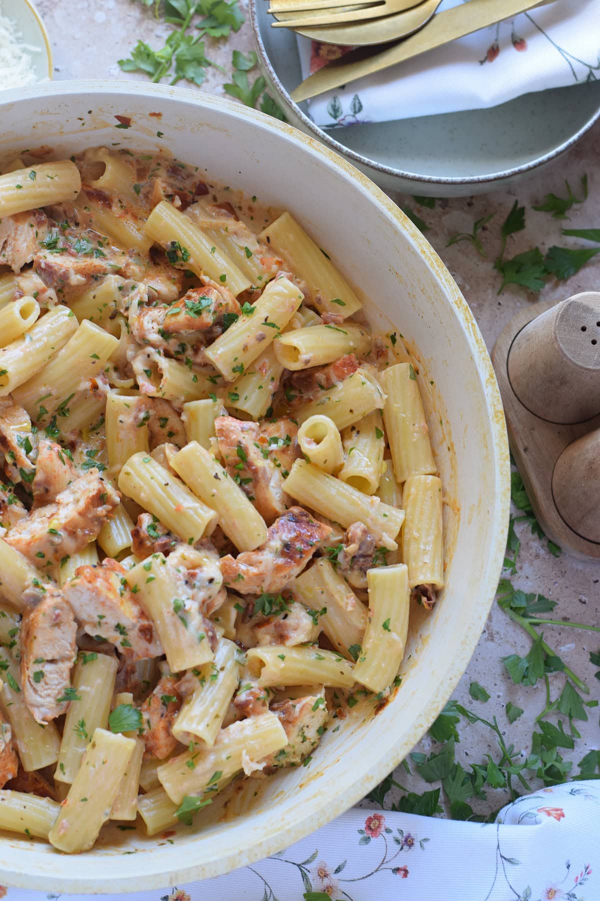 Pasta with creamy sun dried tomatoes in a skillet.
