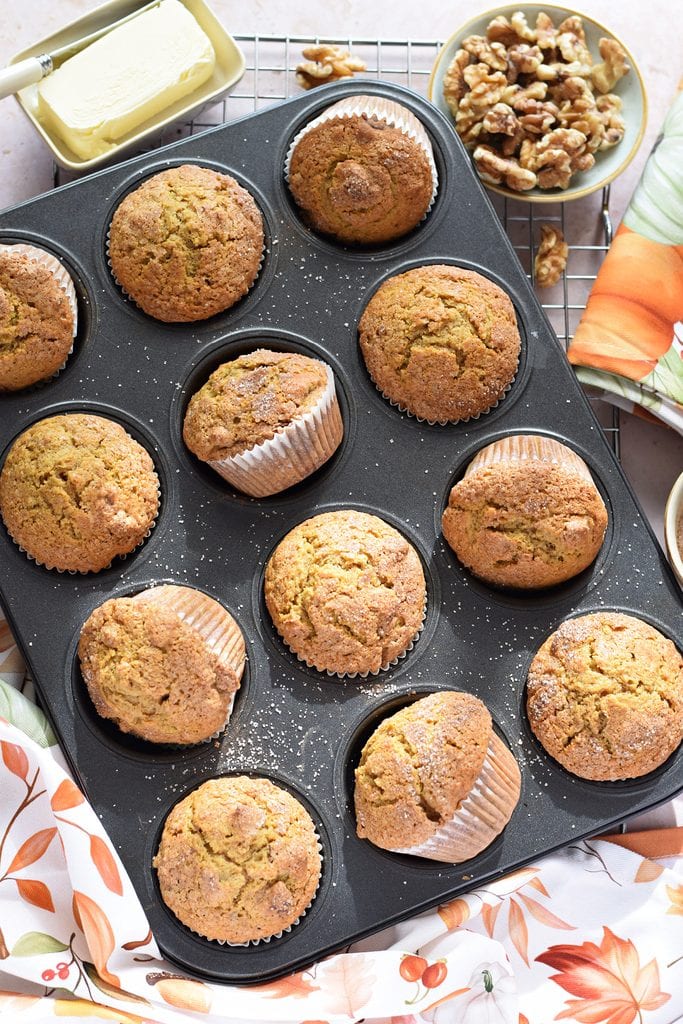 Pumpkin walnut muffins in a baking pan.