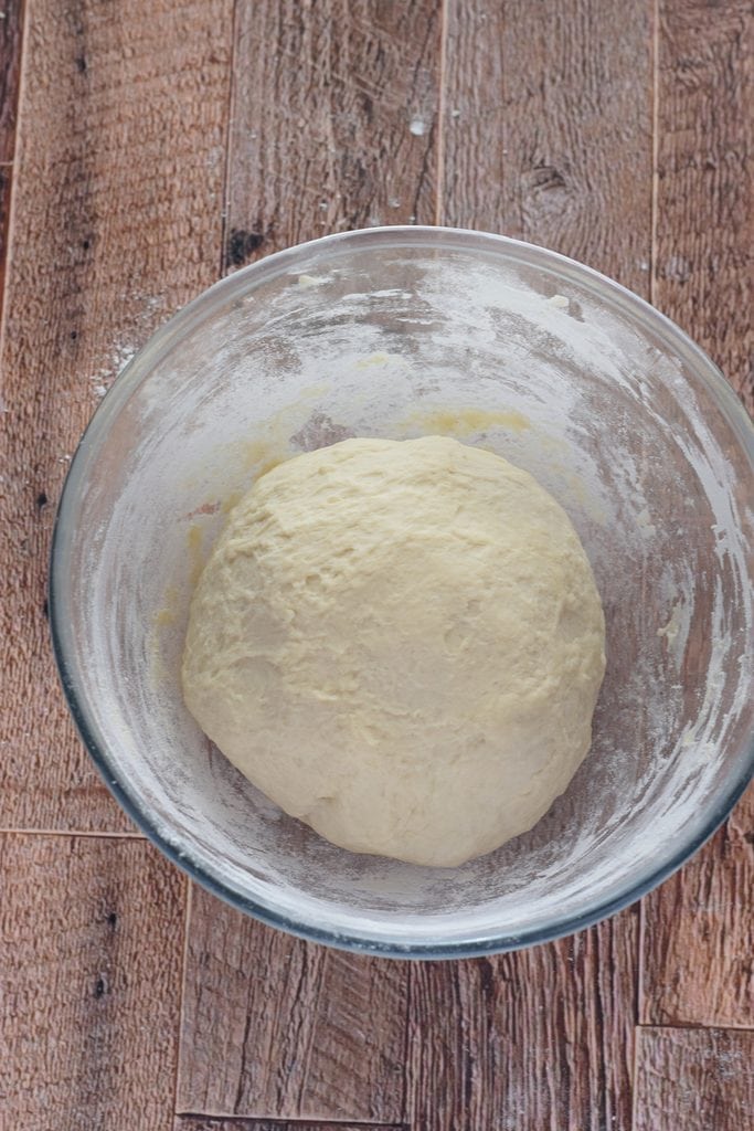 Bread dough in a glass bowl.