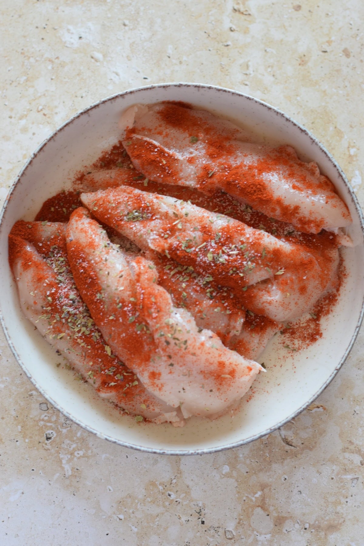 Chicken tenders seasoned with paprika, salt and pepper.