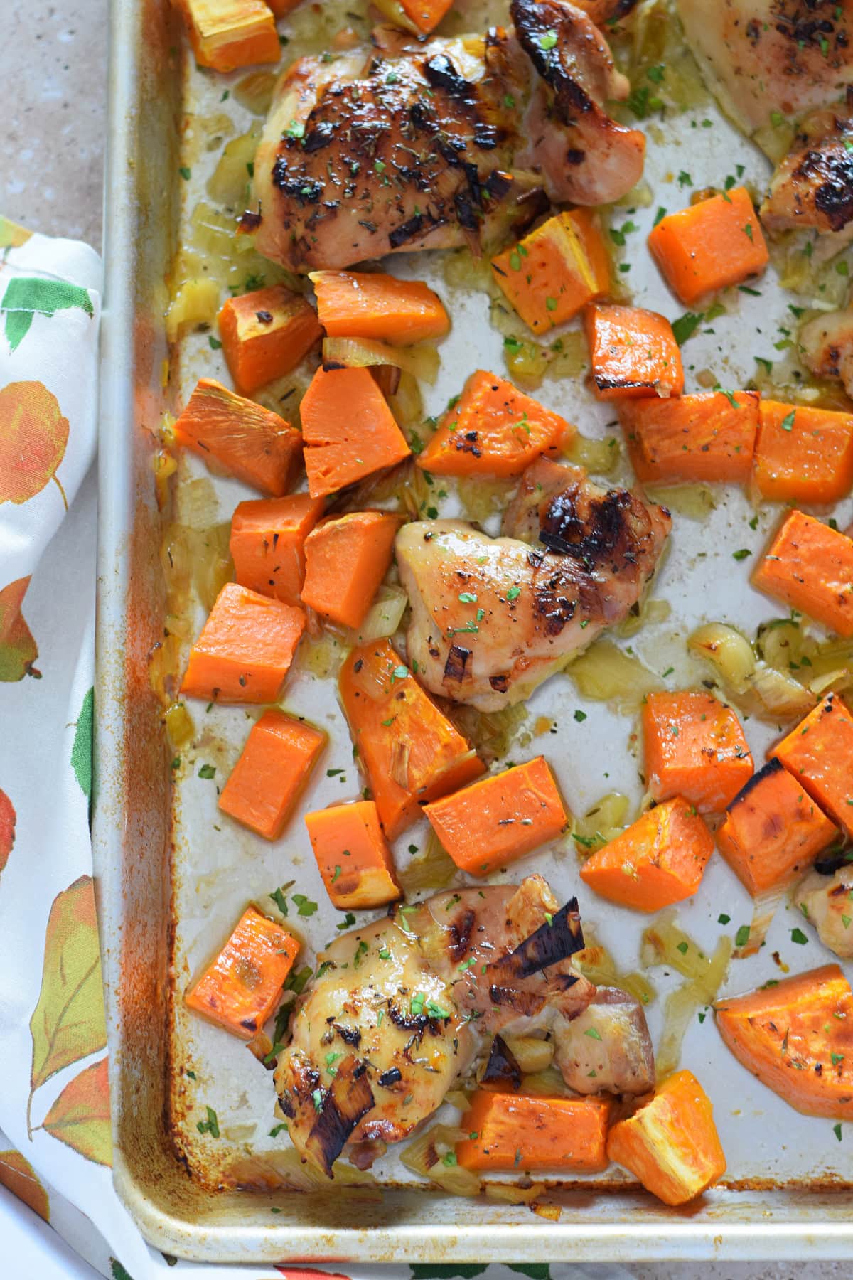 Close up of sheet pan chicken and sweet potatoes.
